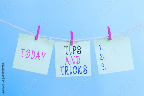 Writing note showing Tips And Tricks. Business concept for means piece advice maybe suggestion how improve Clothesline clothespin rectangle shaped paper reminder white wood desk