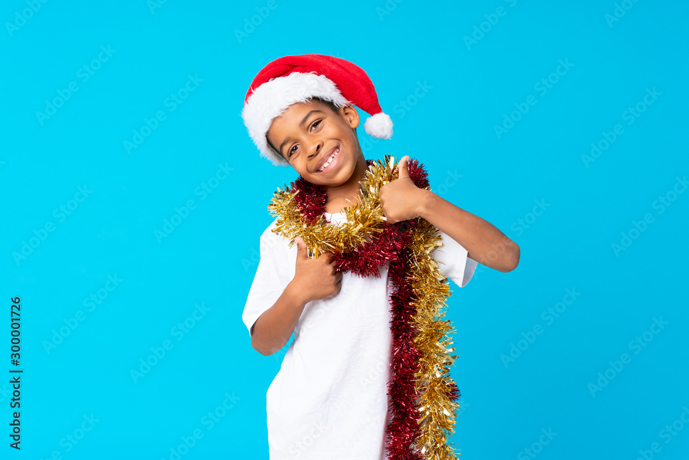 African American boy with christmas hat with thumbs up because something good has happened African American boy with christmas hat with thumbs up because something good has happened