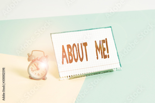 Word writing text About Me. Business photo showcasing telling someone list of your good and bad properties Mini size alarm clock beside a Paper sheet placed tilted on pastel backdrop