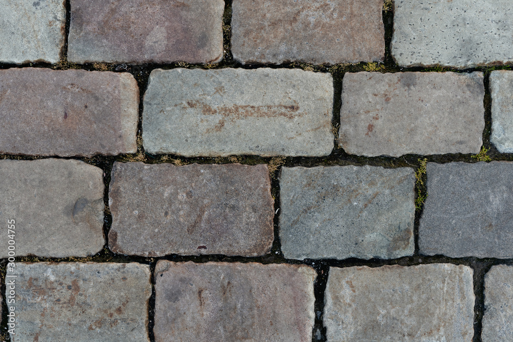 Fototapeta premium Paving. Stone texture and background. The road surface is made of stone. Pedestrian zone made of stone
