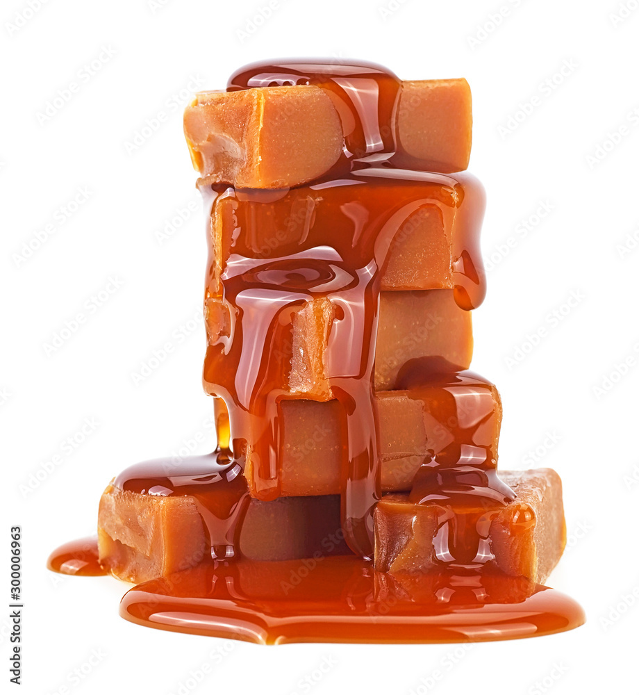 Sweet caramel candies with caramel topping isolated on a white background - obrazy, fototapety, plakaty 
