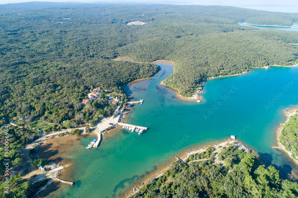 Obraz premium Aerial view of sea and beach in a lagoon on Cres ( isola Cherso ) Island Croatia, close to Punta Kriza ( Punta Croce ). It is a part of national where rocks and sand and forest merge on a coast. 