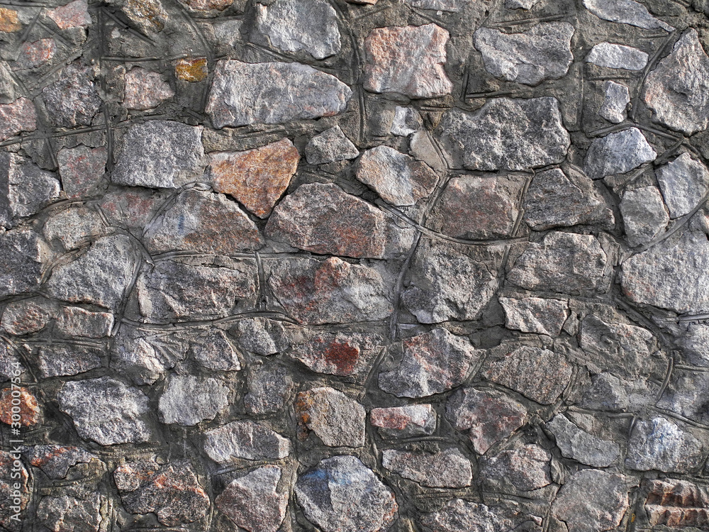 Fototapeta premium Stonework granite wall closeup. Natural background.