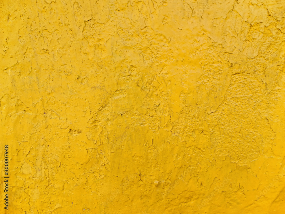 Rough concrete wall surface painted yellow Rough concrete wall surface painted yellow