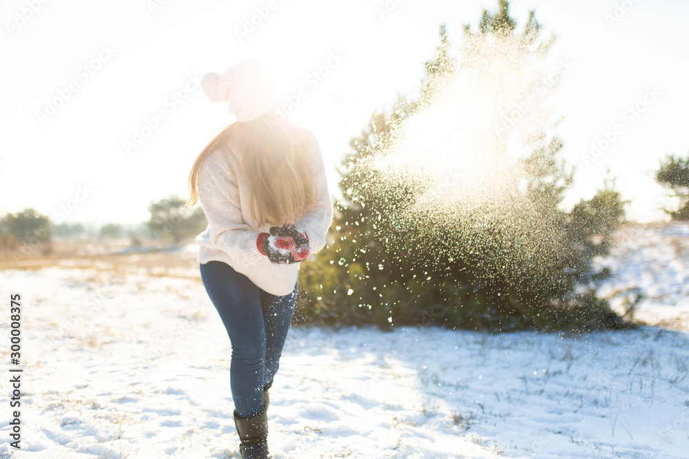 Loving couple play snowballs in winter in the forest. Girl sculpts and throws snowballs. Laugh and have a good time Loving couple play snowballs in winter in the forest. Girl sculpts and throws snowballs. Laugh and have a good time