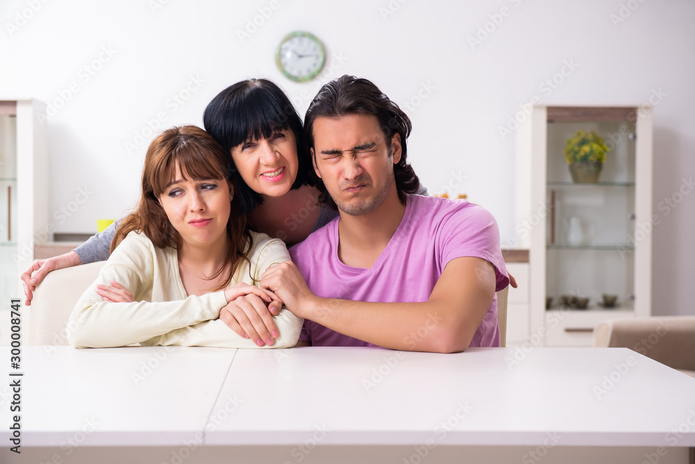 Young family and mother-in-law in family issues concept Young family and mother-in-law in family issues concept