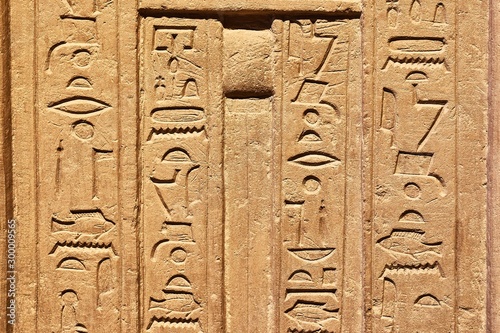 Egiptian hieroglyphs carved in sandstone photo