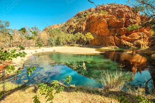 Aerial view of Ellery Creek Big Hole waterhole fed by West MacDonnell Ranges and surrounded by red cliffs. Starting point for Sections 6 and 7 of Larapinta Trail walk in Northern Territory, Australia.