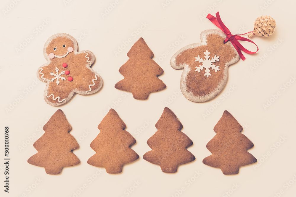 Gingerbread cookies in the shape of Christmas trees, man and mittens on a white background. Top view