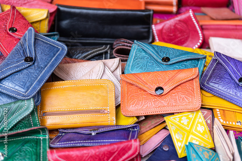 hand-crafted purses in different colors exposed in the foreground. © David San Segundo
