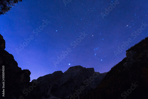 Night sky with stars at Dolomites mountains, Italy