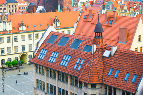 Top aerial view of buildings with tiled roofs, New City Hall and Rynek Market Square in old town historical city centre of Wroclaw, Poland