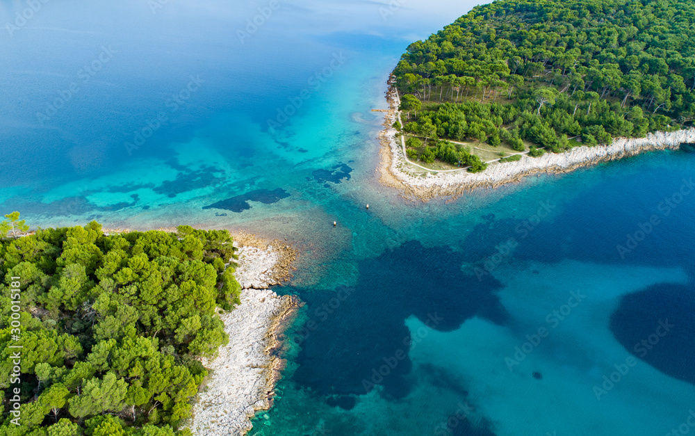 Vertical aerial image of motor boat passing strait close to the coast on the island of Losinj ( Cres ), Croatia. 
