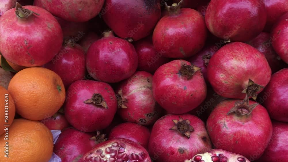 Oranges and pomegranates, on the counter ripe juicy tropical fruits. Oranges and pomegranates, on the counter ripe juicy tropical fruits.