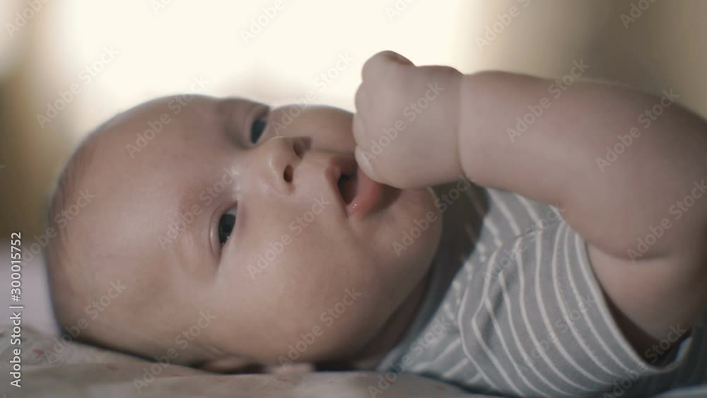 4K, Newborn baby close-up. Child lies and waves his hands 4K, Newborn baby close-up. Child lies and waves his hands