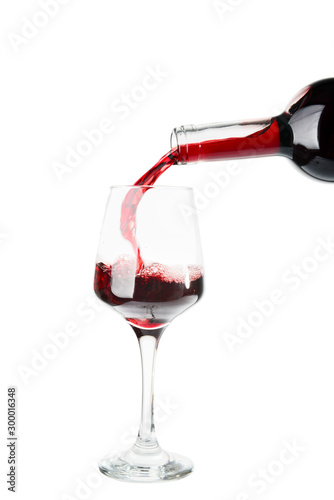Red wine pouring from bottl...