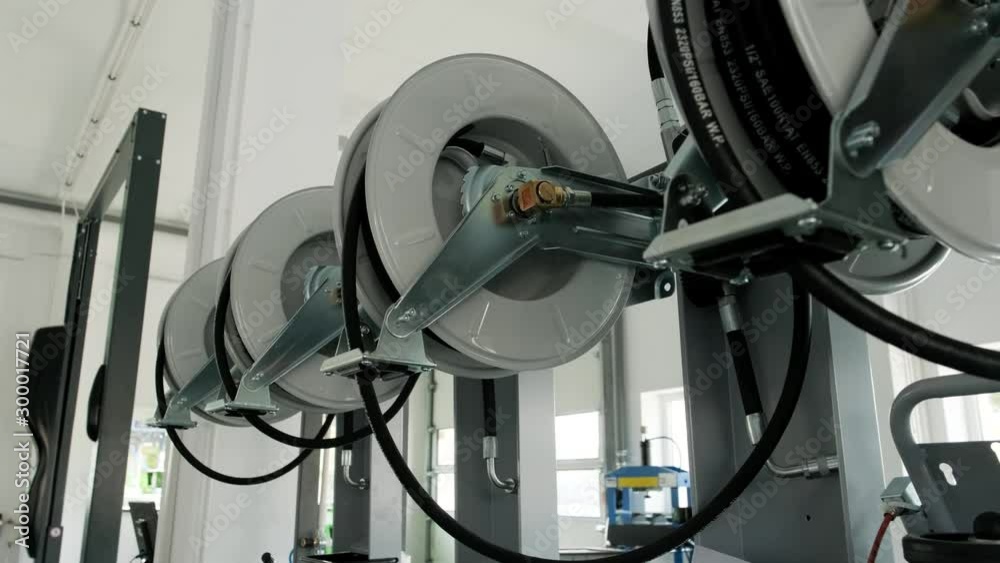 Motor oil in barrels with pump indoors with copy space. Store of lube