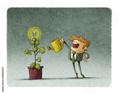 Businessman is watering a plant from which a light bulb blooms.