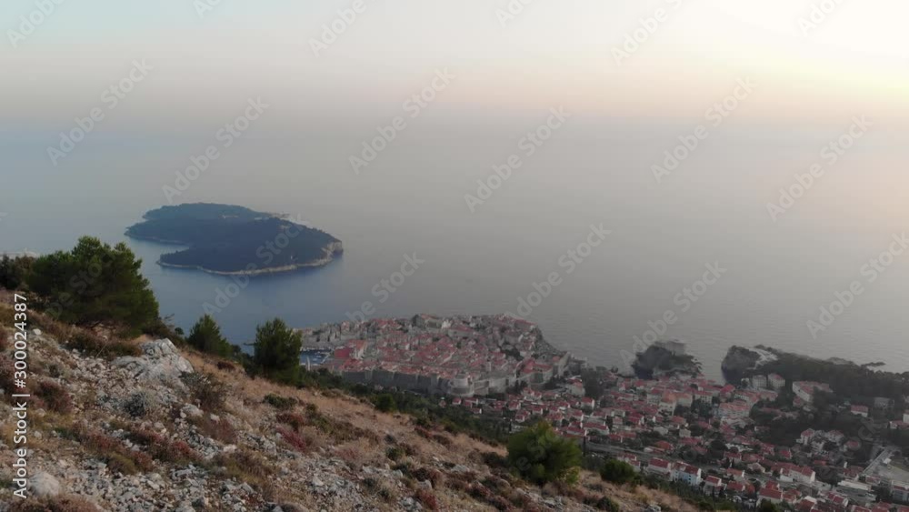 Drone Revealing Old Town Dubrovnik at Sunset. Aerial View of Mediterranean city at golden hour. Drone Revealing Old Town Dubrovnik at Sunset. Aerial View of Mediterranean city at golden hour.