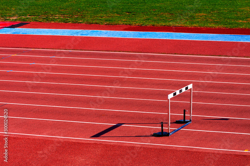 TRACK WITH ATHLETIC JUMP FENCE. SPORTS PHOTOGRAPH.