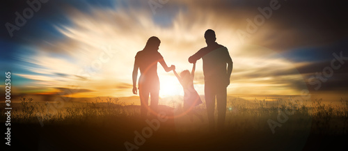 happy family on the hill at sunset. Happy concept of parenting and taking care of children. photo