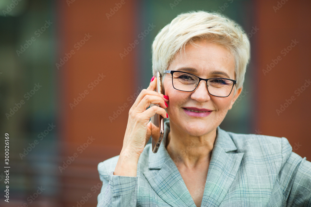 © Alexandr - beautiful stylish woman with a short haircut in a suit calls on the phone © Alexandr - beautiful stylish woman with a short haircut in a suit calls on the phone