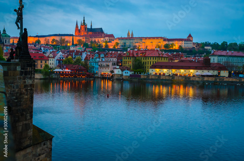 Old Town architecture and Vltava river at night in Prague, Czech Republic.