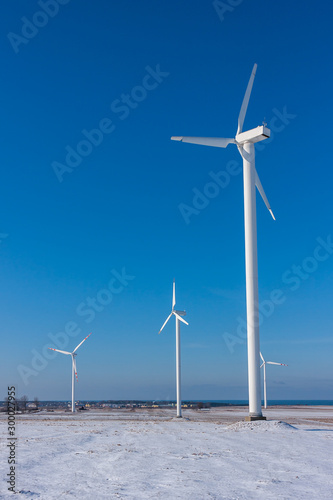 Wind farm in winter on a hill at the seaside