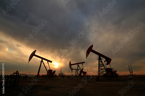 Is operation of pumping unit, sunset in oil field © 杜 海珍