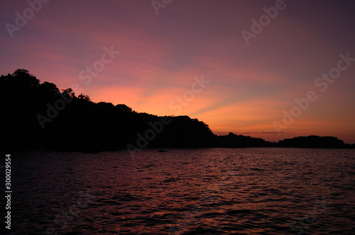 A bright sunset in the Similan Islands in Thailand © Olga