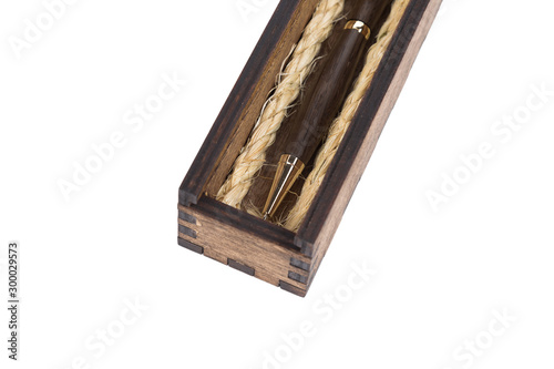 Beautiful wooden box with ballpoint pen inside on a white background.