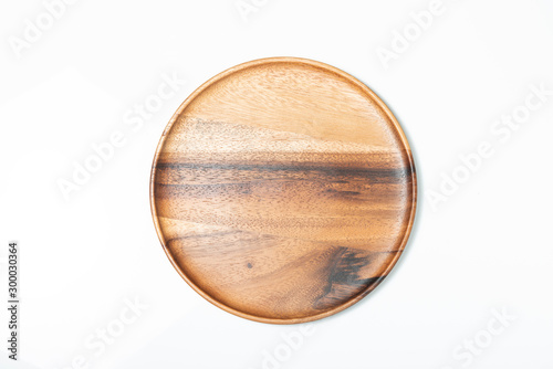 Empty wooden plate isolated on white, top view.