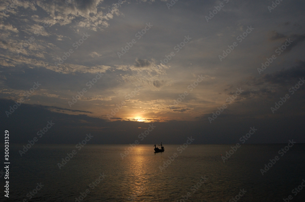 A boat in the calm seas at Mai Khao Beach, Phuket, Thailand