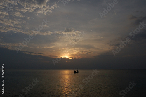 A boat in the calm seas at Mai Khao Beach  Phuket  Thailand