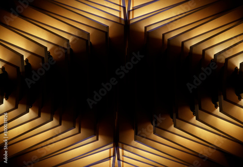 Wooden lath structure. Reworked modern architecture or minimal interior fragment. Irregular geometric background resembling lighting fixture with sharp angles glowing in darkness.