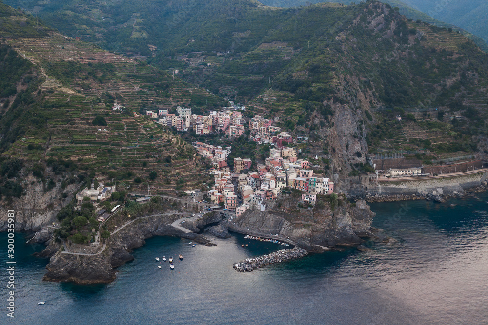 Aerial drone shot view of Riomaggiore village early morning in Cinque Terre, Italy