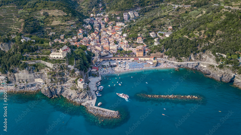 Aerial drone shot view of Monterosso beach filled with parasol in summer time