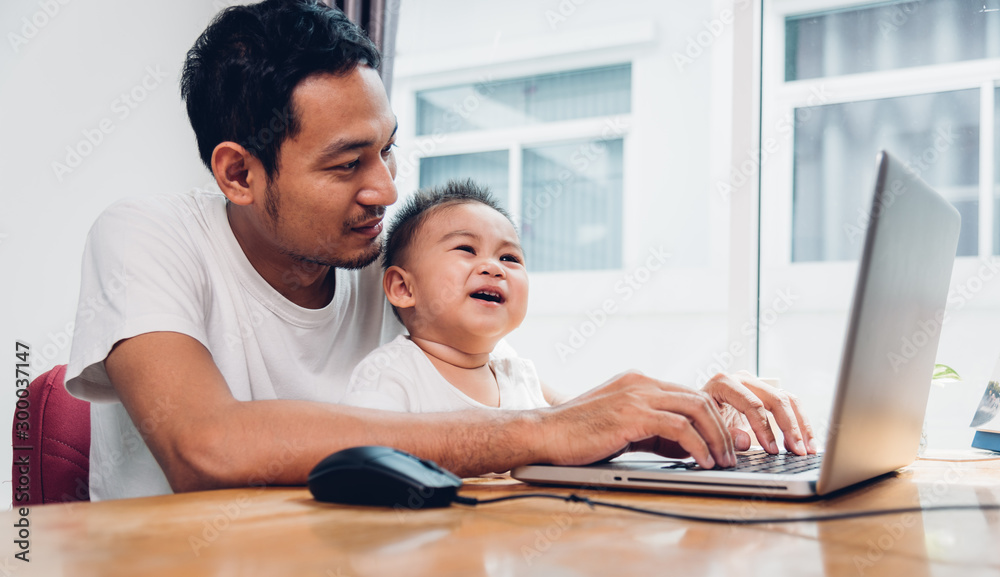 Man father using working on laptop computer Man father using working on laptop computer