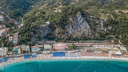 Aerial drone shot view of Monterosso beach filled with parasol in summer time © Davidzfr