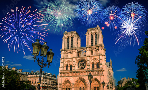 Famous cathedral Notre Dame de Paris with fireworks in Paris, France.