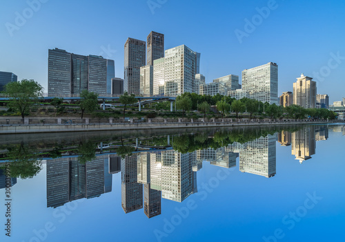 Business district office buildings and water reflection in Beijing . © hallojulie