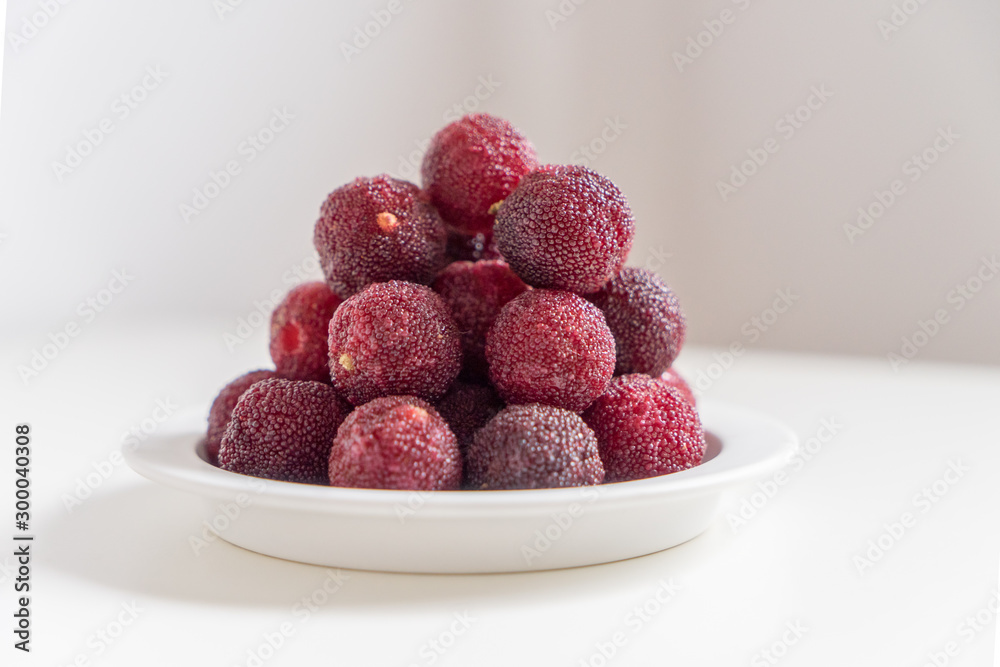 Sweet and sour red fruit bayberry, before a white color background Sweet and sour red fruit bayberry, before a white color background