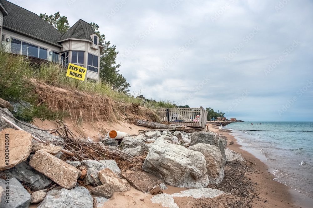 Samolepka Beach houses on Lake Michigan, lake erosion dangerously close to houses, half th