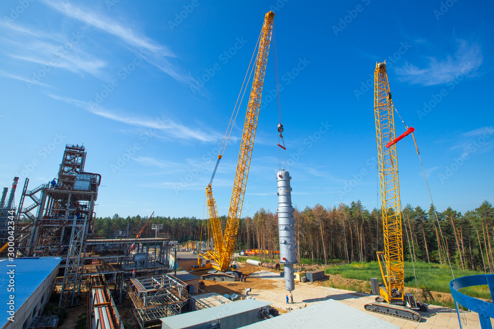 MOSCOW, RUSSIA, 08.2018: The construction of an oil refinery, near Moscow. industrial cranes (LIEBHERR), construction and installation of components of an oil refinery in near Moscow.