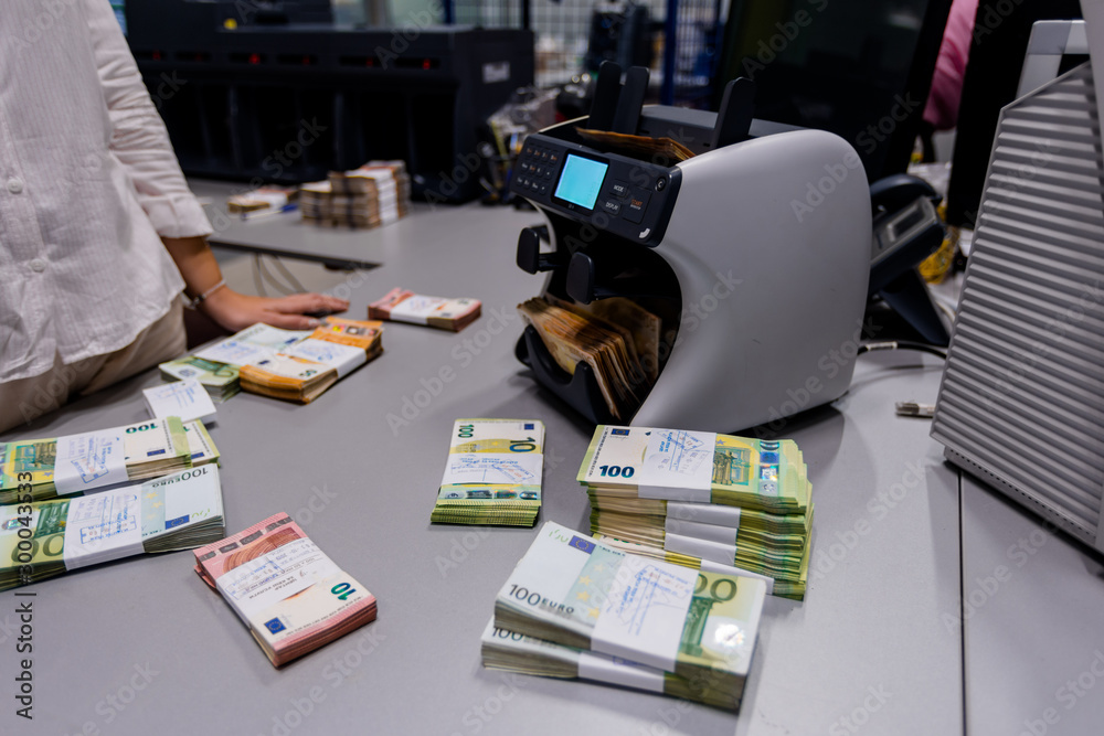 Various types of euro € banknotes on an office desk
