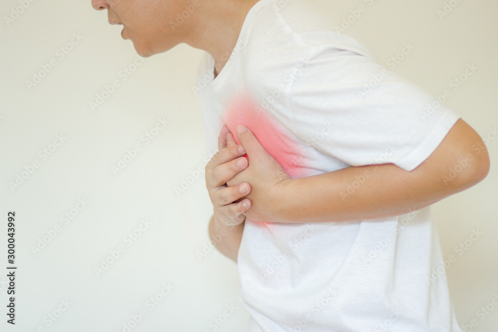 Sick man having painful Chest having heart attack at home,Hands squeezing Chest.healthcare concept Sick man having painful Chest having heart attack at home,Hands squeezing Chest.healthcare concept
