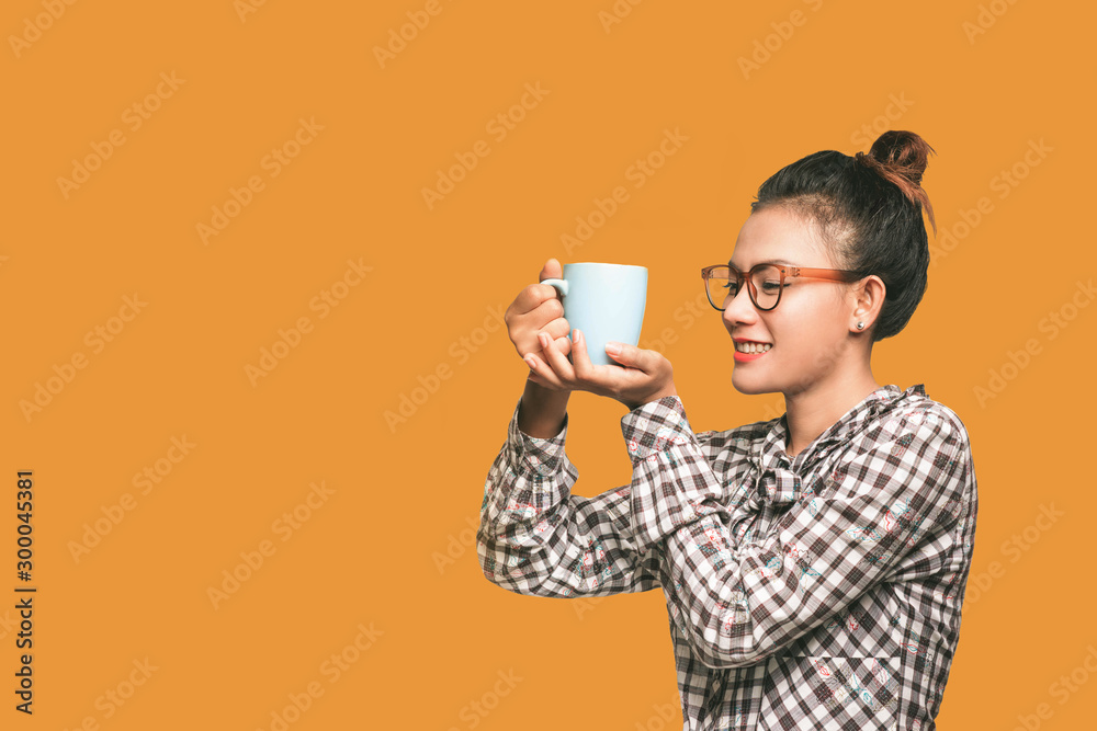 The smiley face of an Asian woman when Looking at her drink glass Happy mood The smiley face of an Asian woman when Looking at her drink glass Happy mood