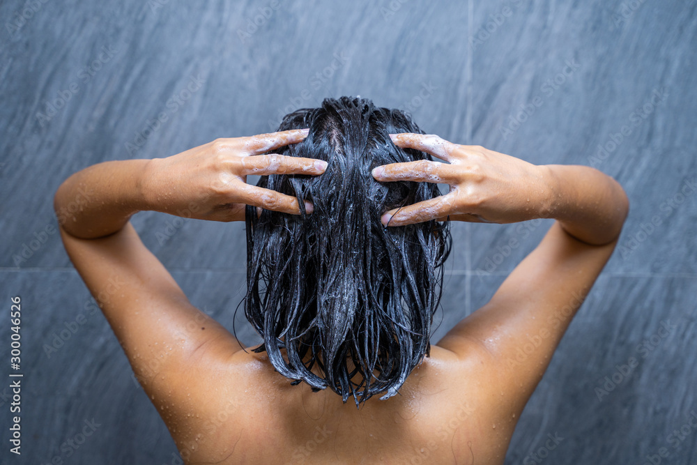 Naklejka premium woman shower and wash hair in bathroom