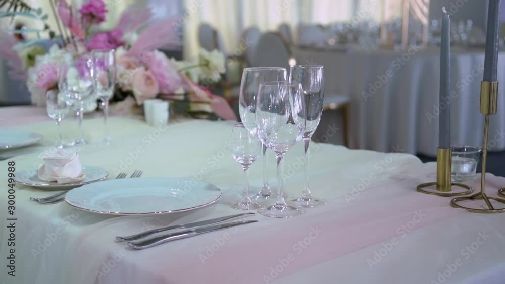 Glasses, plates, Cutlery and napkins. Decorated tables with flowers for the party. Wedding reception, birthday, anniversary Glasses, plates, Cutlery and napkins. Decorated tables with flowers for the party. Wedding reception, birthday, anniversary