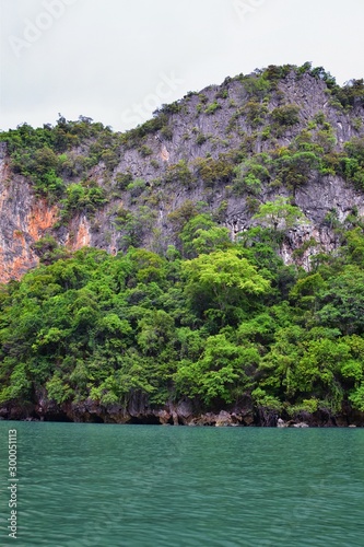 Island, Ocean views near Phuket Thailand with Blues, Turquoise and Greens oceans, mountains, boats, caves, trees resort island of phuket Thailand. Including Phi Phi, Ko Rang Yai, Ko Li Pe and other is